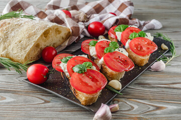 Italian Bruschetta on Ciabatta: Fresh Tomatoes, Garlic, and Olive Oil on a Wooden Table, Rustic
