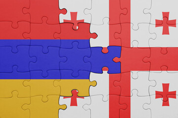 puzzle with the colourful national flag of armenia and flag of georgia .