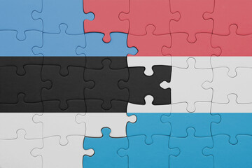 Fototapeta premium puzzle with the colourful national flag of estonia and flag of luxembourg .