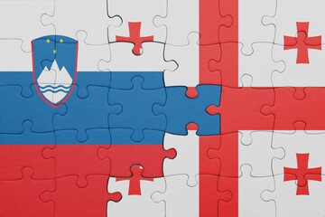 puzzle with the colourful national flag of slovenia and flag of georgia .