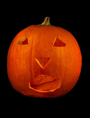 Scary Halloween pumpkin with eyes glowing inside at dark background