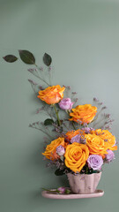Floral tea cup with orange and purple flowers with leaves and flowers in the background