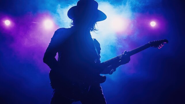 Silhouette of a Musician Playing Guitar on Stage with Blue and Purple Lights.