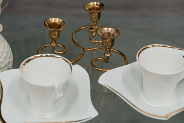 Elegant Table Setting with Golden Candle Holders and Fine China