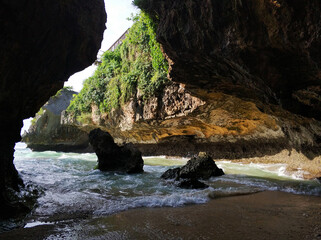 The view from a cracked cave in the rock to the incredibly beautiful ocean on the tropical island...