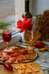 Wine glass with red wine on windowsill. Vertical. Rustic style, simple serving, good quality products
