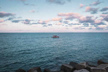 Excursion boat in the Mediterraenan sea on the coast of Italy. Adventure in the south of Italy.