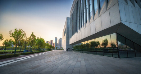 Fototapeta premium Glass Building Exterior in Cityscape with Evening Sky
