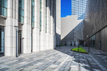 Fototapeta premium Modern Corporate Plaza with Glass Skyscrapers and Sunlight