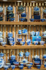 Exquisite Display of Blue and White Ceramic Tea Sets in a Charming Showcase