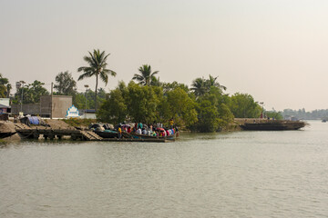 Naklejka premium Country boat on river showcasing local life in Sundarban Tiger Reserve, India