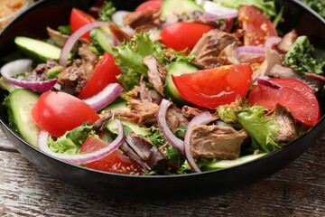 Delicious fresh tuna salad on wooden table, closeup