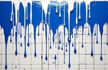 Vibrant blue paint dripping over white tiled wall in artistic splash design