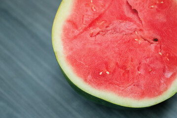 slices of red watermelon on a wooden background