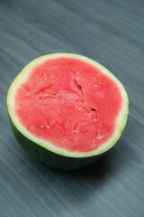 slices of red watermelon on a wooden background