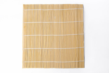 The sushi rolling tool is called makisu or rolling mat for background