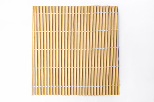 The sushi rolling tool is called makisu or rolling mat for background