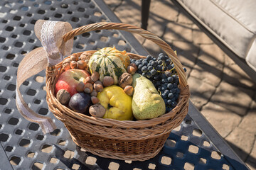 autumn basket full of fruit, hazelnuts, quinces, apples, grapes,