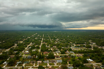 Landscape of dark ominous clouds forming on stormy sky before heavy thunderstorm over rural town...