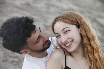 closeup portrait of cute loving young couple on the beach