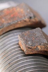 A close-up of a rusty, broken nut attached to a plumbing pipe nipple, showing corrosion and deterioration on metal surface.