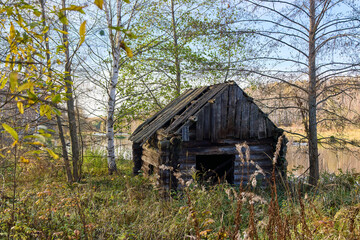 Old, Crumbling Russian Bathhouse in Autumn Landscape