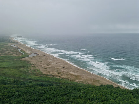 It is a foggy seascape.