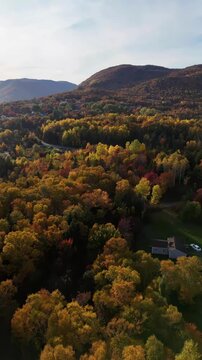 Cape Smokey Mountains along Ingonish Beach, Cabot Trail, Cape Breton, Nova Scotia, Canada. Incredible blue ocean waters with  the autumn fall foliage colors.  [Vertical Video]
