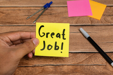 handwritten great job text words on sticky notes over wooden table