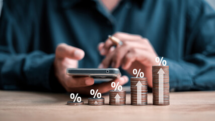 Interest rate and dividend concept, wooden block with percentage symbol and up arrow, return on stocks and mutual funds, long term investment for retirement.