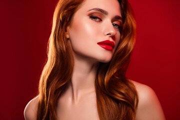 Photo of attractive gorgeous woman teasing look camera shoulders off isolated on red color...