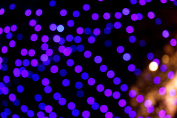 Many soft blue and purple blurry bokeh light on dark background in Christmas and New Year festival day, can use for background