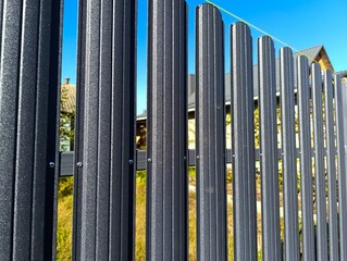 Fototapeta premium A close up of a metal fence with a blue sky in the background