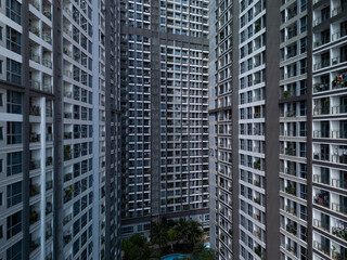 Modern luxury high-rise buildings in dramatic light showing density and height of large construction project landscape format with garden.