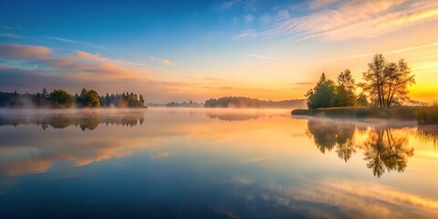 A serene lake at dawn with mist rising from the water surface, peaceful scene, serene lake, water surface, nature landscape, tranquil environment