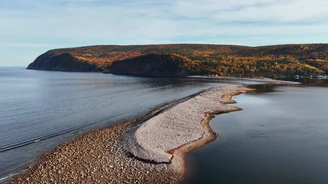 Ingonish Beach along Cabot Trail, Cape Breton, Nova Scotia, Canada. Incredible blue ocean waters with  the autumn fall foliage colors. 