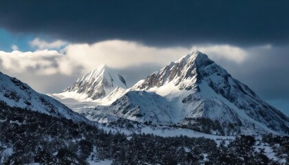 Dramatic snow-capped peaks with storm clouds gathering above, creating a powerful winter 