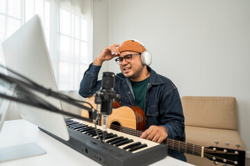 Professional Musician with condenser microphone and tablet for Mixing Mastering music. Music...