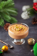 Homemade butterscotch pudding in glass cream bowl on the table. National Butterscotch Pudding Day