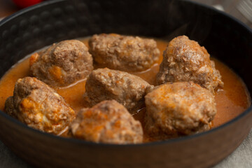Meat balls in meat sauce in a frying pan