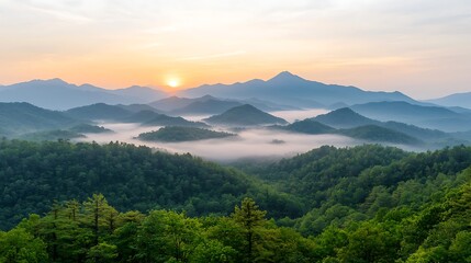 Fototapeta premium Breathtaking sunrise over rolling green mountains with misty valleys at dusk in a serene natural landscape