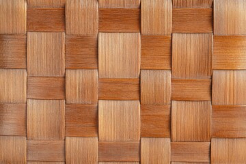 Close-up of woven wooden texture with natural patterns and warm tones