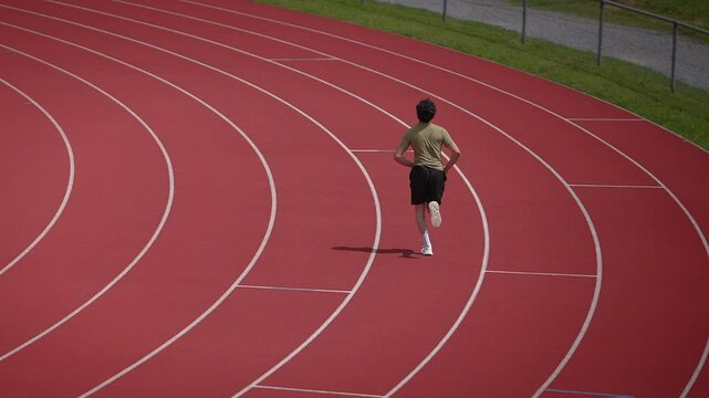 A young runner trains on a vibrant track to achieve personal goals through dedication