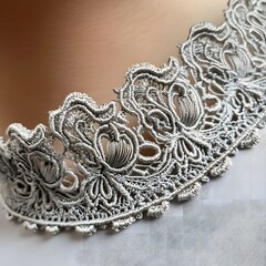 Obraz premium A close-up of a decorative band made from intricate lace, showcasing its fine details.