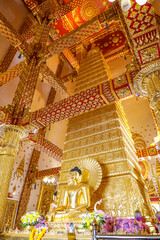 Wat Phra That Nong Bua, Ubon Ratchathani, inside there is the Phra That Sri Maha Bodhi Chedi, a replica of the Chedi in Bodh Gaya, India, stucco sculptures, candles, and two large Naga statues.