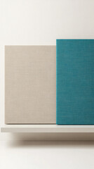 Canvas art displays in neutral beige and vibrant teal colors arranged on a white shelf