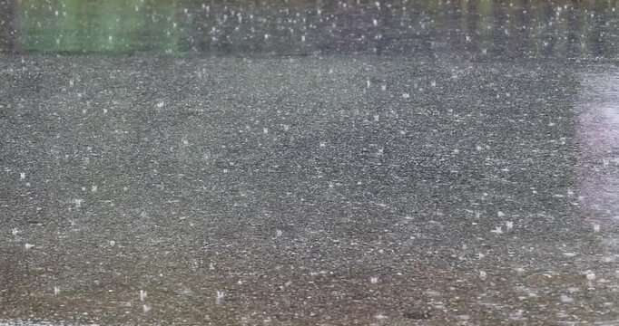 Raindrops hit the road, recorded with a professional 4K high-definition camera in Myanmar.