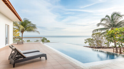 Fototapeta premium A tranquil beachfront villa with a stunning infinity pool overlooking the serene ocean at sunset