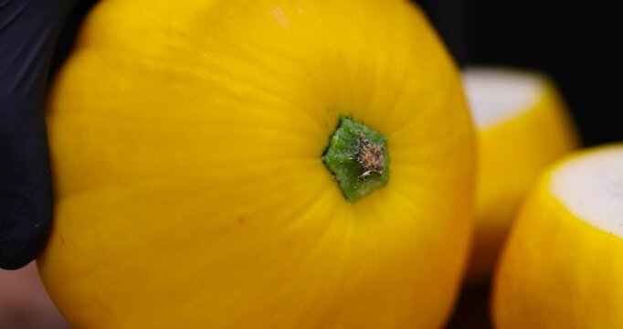 cut yellow ripe pumpkins on the table in close-up, harvested squash on the table during cooking