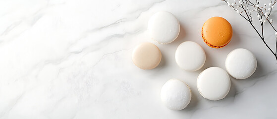 Delightful overhead view of assorted macarons on a marble countertop showcasing a palette of colors and textures for culinary enthusiasts